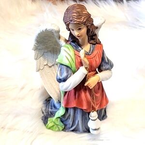 Mark O"well‎ 1997 hand painted kneeling angel with lantern.